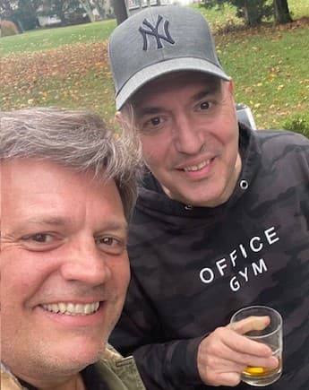 Michael Scarano and his closest friend Fotis, smiling together outdoors