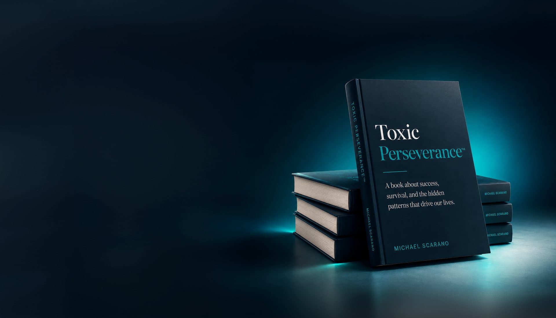 The Toxic Perseverance™ hardcover standing on a stack of books, lit teal against a dark studio background