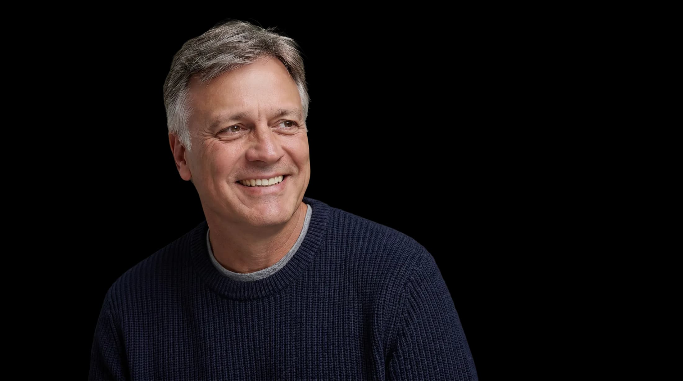 Michael Scarano smiling, wearing a navy sweater